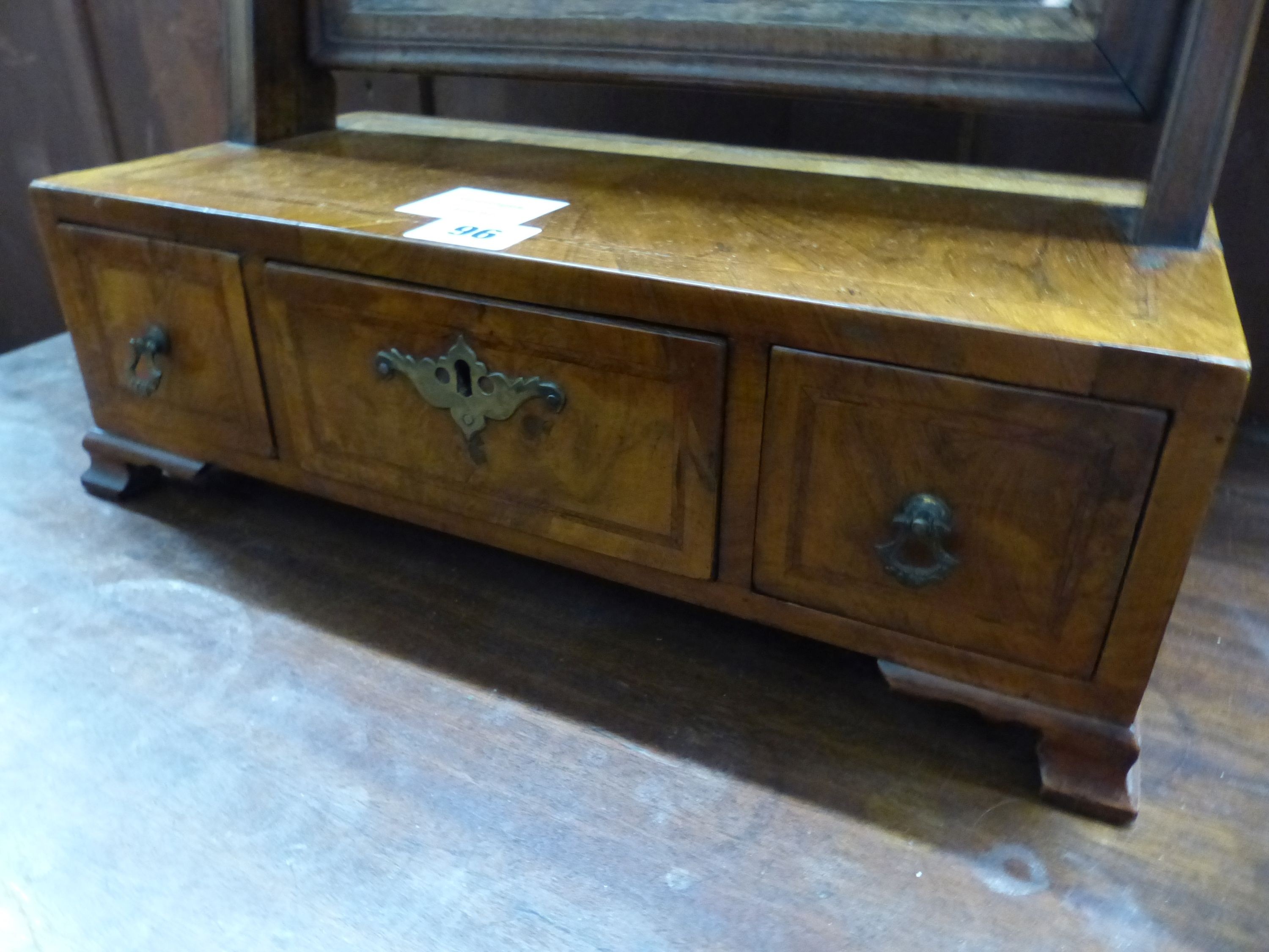 An 18th century and later figured walnut toilet mirror, the box base fitted with three drawers, W.36cm D.18cm H.58cm